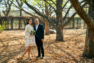 Obraz premium Young male and woman just married. Concept of happy family. Modern family outdoor.