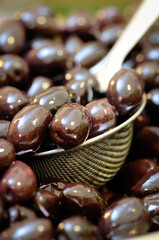 black olives taken with an aluminum colander