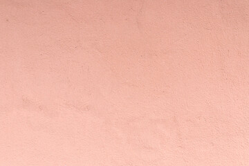 Texture of plastered wall painted with peacj color. Exterior paint, background, close-up, wallpaper, copy space