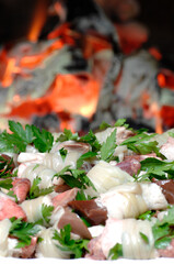 typical dish of the Puglia region in southern Italy called Gnemeridde made with lamb entrails cut and rolled and cooked on the grill