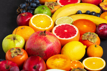 Naklejka na ściany i meble Fruit sources of vitamins, background fruits Fresh . Fresh fruits. Assorted fruits colorful, clean eating, Fruit background. Top view.close up