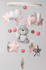 Baby crib mobile - kids toys, on light background.