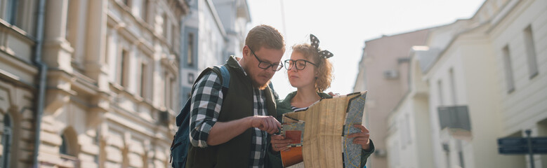 A couple of tourists in a European city with a map © Anna