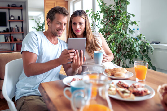 Couple have breakfast at home.