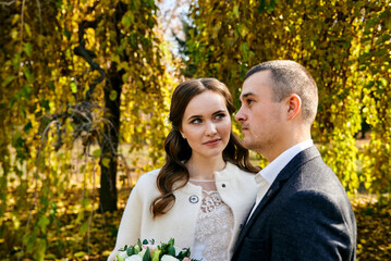 Fototapeta premium Young male and woman just married. Concept of happy family. Modern family outdoor.