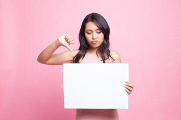 Young Asian woman show thumbs down with white blank sign.