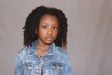 Cute African American Girl with curl hair grey background