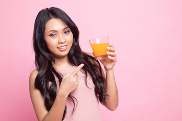 Young Asian woman point to orange juice.