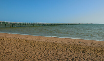 bridge on the shore of the beautiful sea goes to the horizon