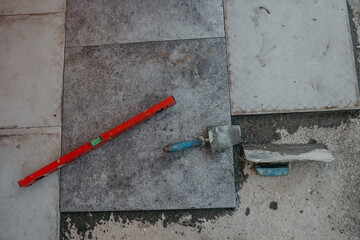 Ceramic tiles and tools for tiler ceramic tiles installation Home improvement, renovation ceramic tile adhesive, mortar, level