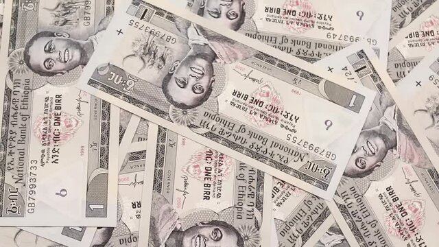 A close up video of gray Ethiopian one birr notes rotating in a circle