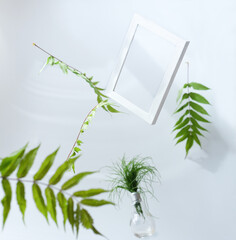 Beautiful flying green leaves background with white frame.