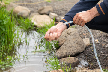 man washing hand in the street