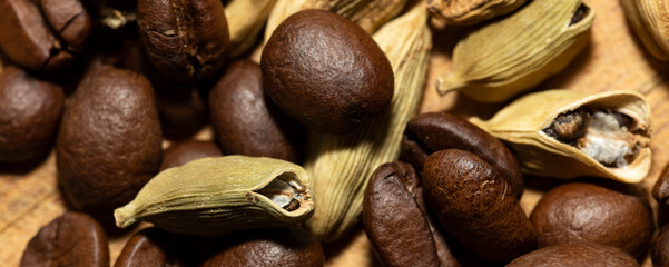 Black coffee beans and Green cardamom pods.