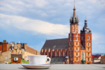 A Cup of coffee with view of Church Bazylika Mariacka or towers of st.Mary's. Top view from roof or...