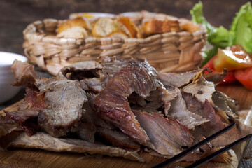 Typical Brazilian barbecue on a cutting board with side dishes