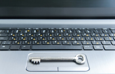 Internet security and data protection concept. Cybersecurity concept. Key on black and gray computer keyboard - computer security concept. Selective focus