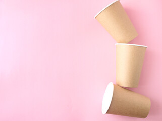 disposable paper cup on pink background. ecology, environmental pollution by plastic, waste recycling concept. flatlay, copyspace