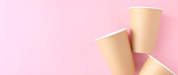 disposable paper cup on pink background. ecology, environmental pollution by plastic, waste recycling concept. flatlay, copyspace
