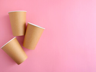 disposable paper cup on pink background. ecology, environmental pollution by plastic, waste recycling concept. flatlay, copyspace