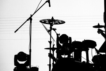 silhouette of a modern drum kit on stage on a white background. a concert of a popular group and a...