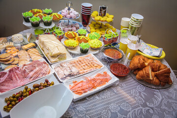 Round table with various cookies, tarts, cakes and cupcakes