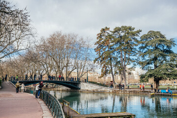Fototapeta premium Meribel, France - July 17, 2019: photography of the city embankment. People walk along the lakeshore
