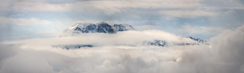 Fototapeta na wymiar Mountain peaks in the clouds Ile Alatau National Park Tien Shan