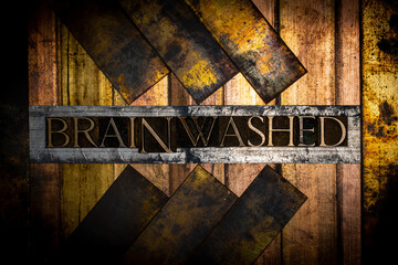 Photo of real authentic typeset letters forming text Brainwashed on vintage textured silver grunge...