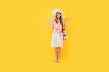 attractive happy young woman in sunglasses and a summer hat, on an yellow background