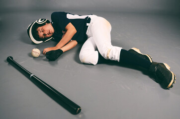 Young male baseball player knocked out after hit by pitch - Powered by Adobe