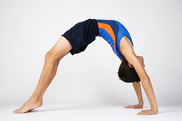 Male child gymnast doing floor routine poses
