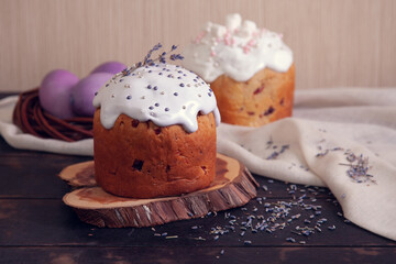 Easter cakes decorated with lavender and marshmallows and painted Easter eggs in a wicker nest