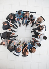 Business meeting concept with people sitting around a round tabl