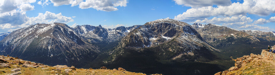 Panorama from Forest Canyon overlook in Rocky Mountain National Park,  Colorado, USA, with unrecognizable people admiring mountain tops and cirque formed by glacial erosion long ago