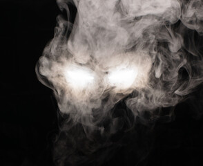 Ominous luminous eyes looking out of the darkness illuminate the swirling smoke with rays of white light