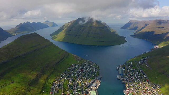 4k drone flight moving to the side footage (Ultra High Definition) of Klaksvik town. Aerial morning scene of Bordoy island, Faroe, Kingdom of Denmark, Europe. Traveling concept background.
