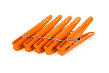 Orange plastic clothespins isolated on white background. Plastic clips. Close-up. Full depth of field.