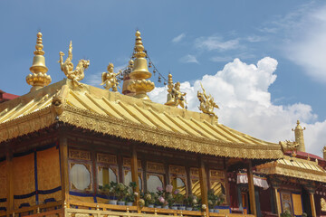 Jokhang temple gplden roof in Lhasa, Tibet with beautiful clouds