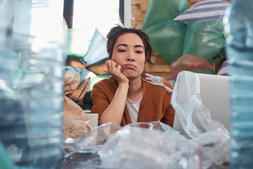 Slatternly young woman looking at camera with idle face