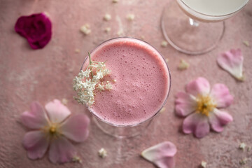Obraz na płótnie Canvas A glass of kefir with blended raspberries and elder flowers