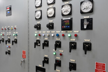 An electrical generation panel with buttons, gauges and switches