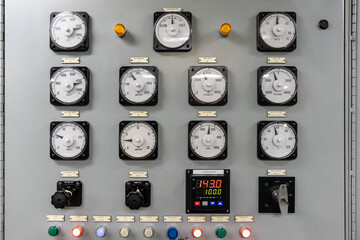 An electrical generation panel with buttons, gauges and switches