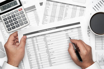 Top view of businessman working with financial statements. Modern black office desk with notebook, pencil and a lot of things. Flat lay table layout.