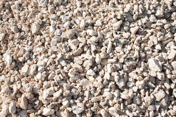 Texture of small stone of white color. Road surface base