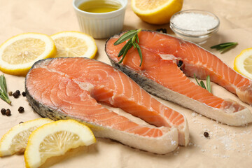 Salmon meat and spices on baking paper background, close up