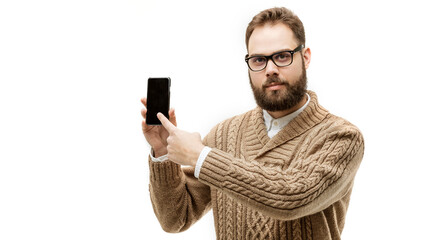 closeup portrait of handsome man pointing index finger on his smartphone