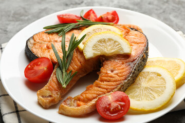 Composition with tasty grilled salmon on gray background, close up
