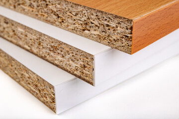 Stacked chipboard with veneer. Material for the construction of furniture in the carpentry shop.