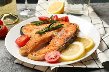 Composition with tasty grilled salmon on gray background, close up